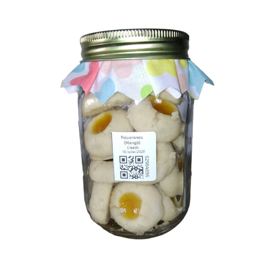 Jar of white half spherical polvorones cookies with a black and white label on a white background