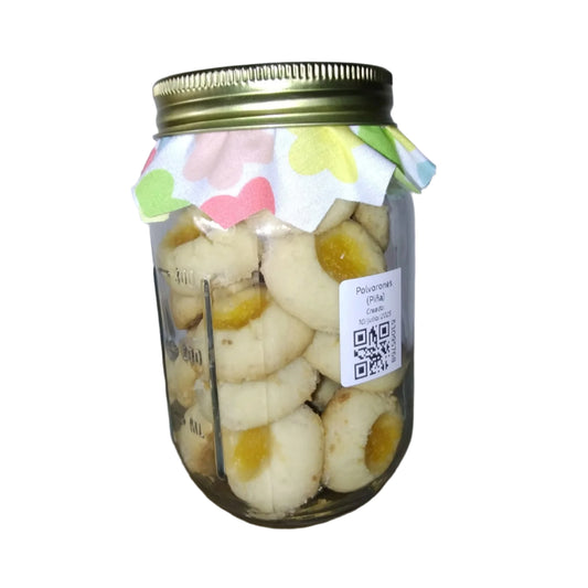 Jar of cookies with a decorative label on a plain background