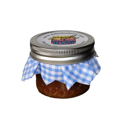 Jar of jam with a metal lid and blue checkered cloth on a white background.
